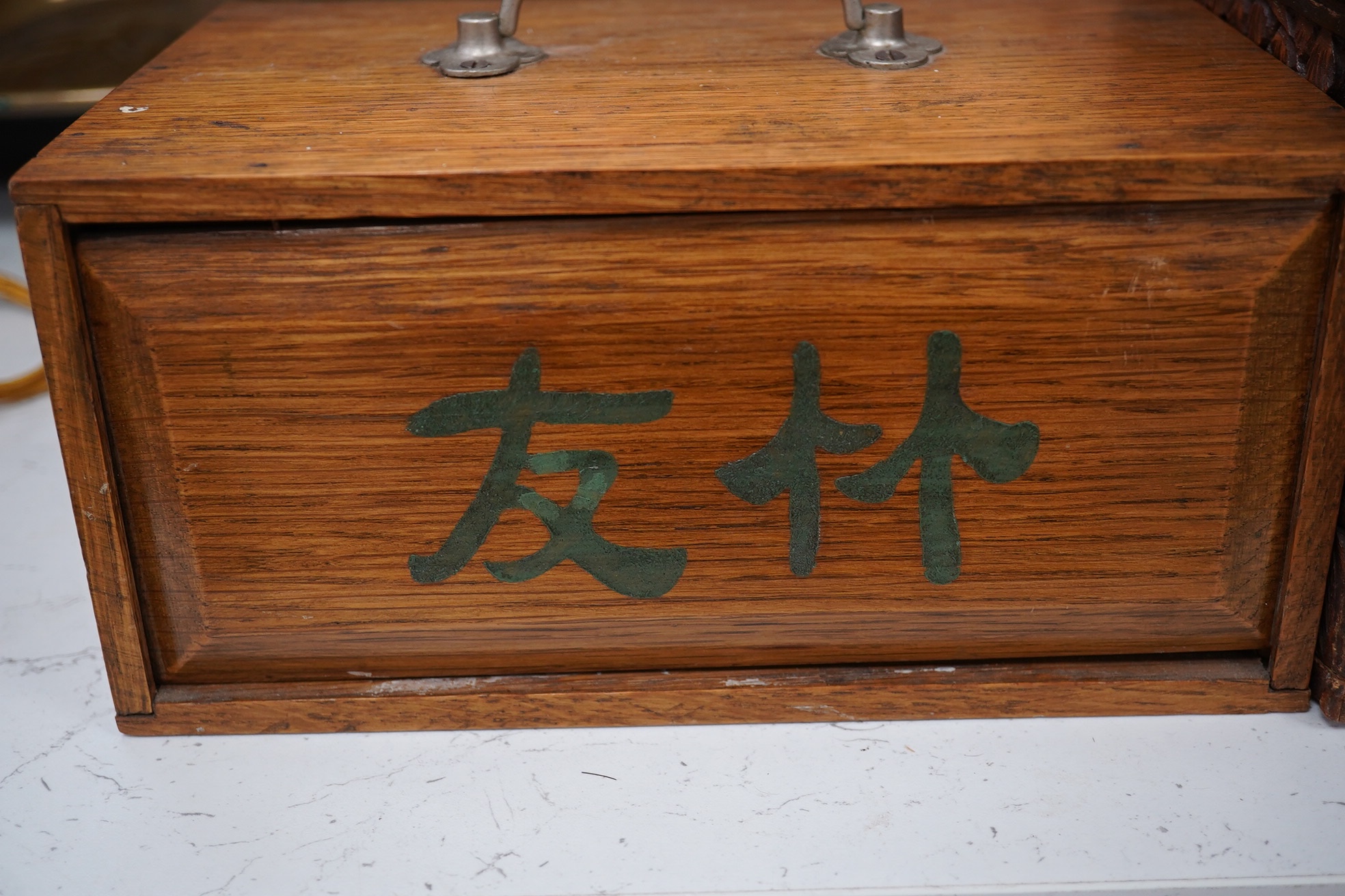 A Chinese carved small camphor box and an oak cased Mahjong set, camphor box 31cm wide x 17cm high. Condition - fair